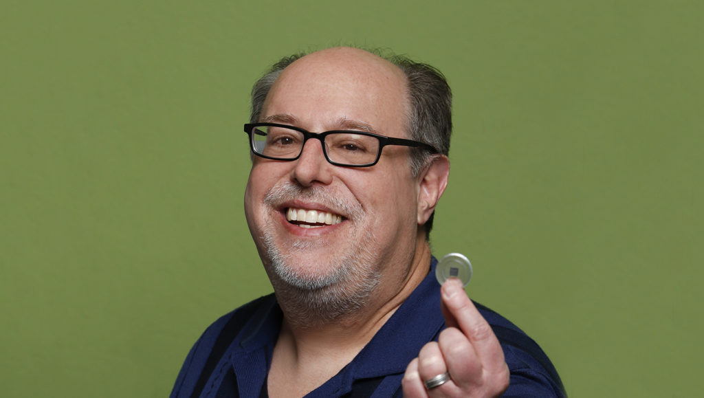 Photo of Steve Teig, founder and Co-CEO of Perceive, holding an Ergo chip in his fingers. 